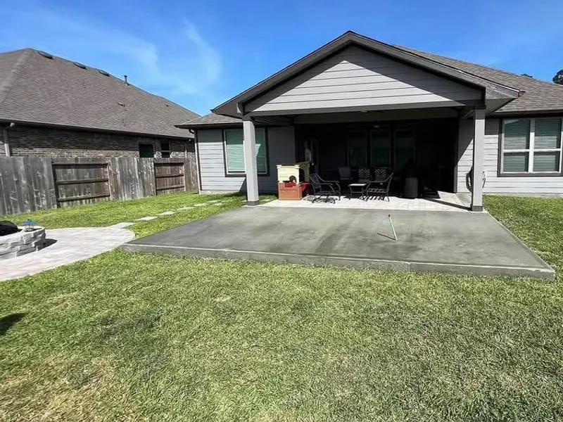 Large concrete patio poured behind a new Houston home