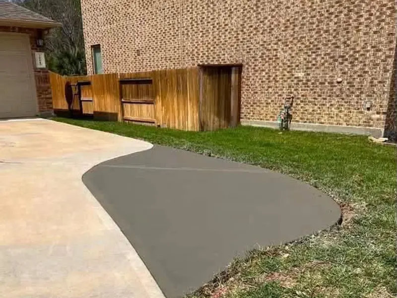 Curved driveway extension added beside a garage